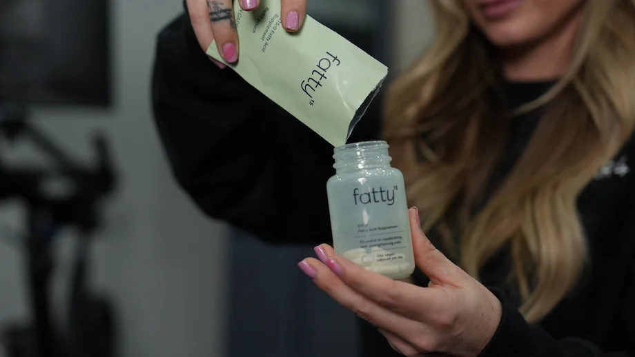 An image of a woman filling a Fatty15 bottle