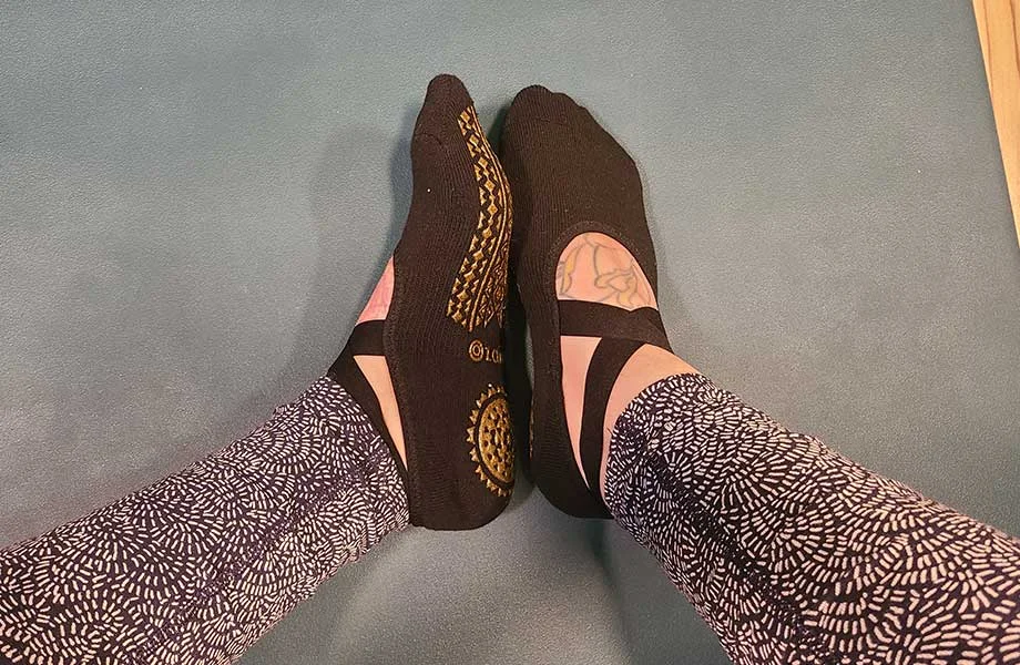 wearing ozaiic pilates socks one foot down