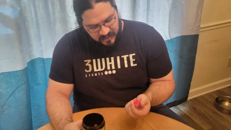 Olympian Caine Wilkes examines a Bounce Nutrition Creatine Gummy.