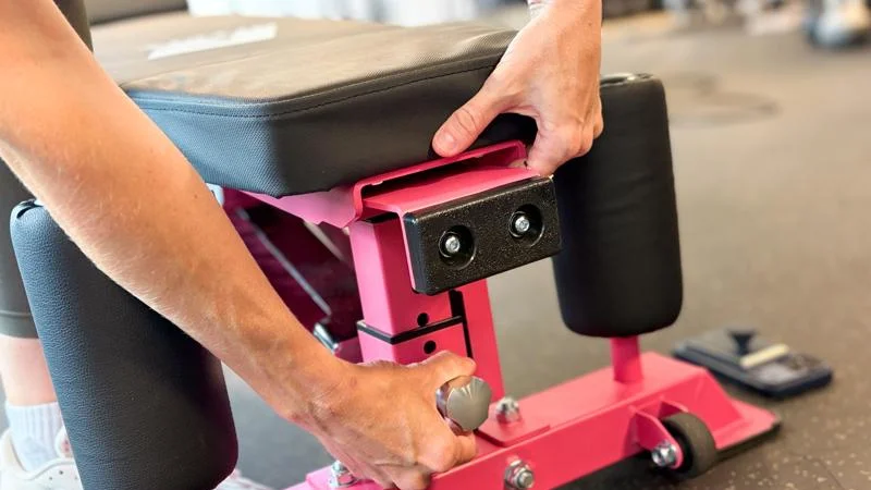 A person adjusts the seat on a Ritfit Gator Bench.
