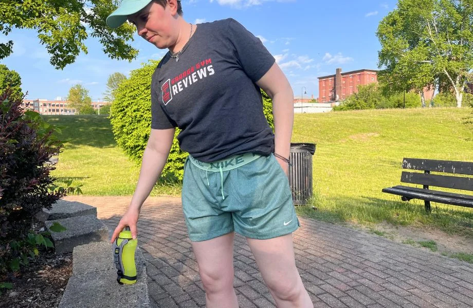 Woman standing with a water bottle while wearing the Nike Attack Shorts