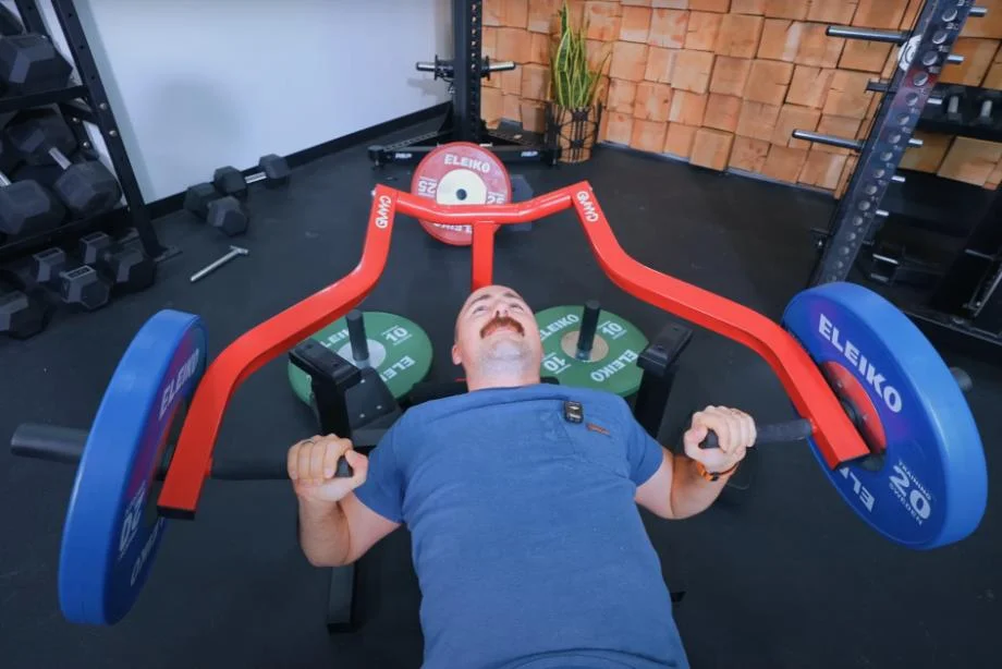 Looking down on Coop as he does bench presses on the GMWD Bench Press Machine.