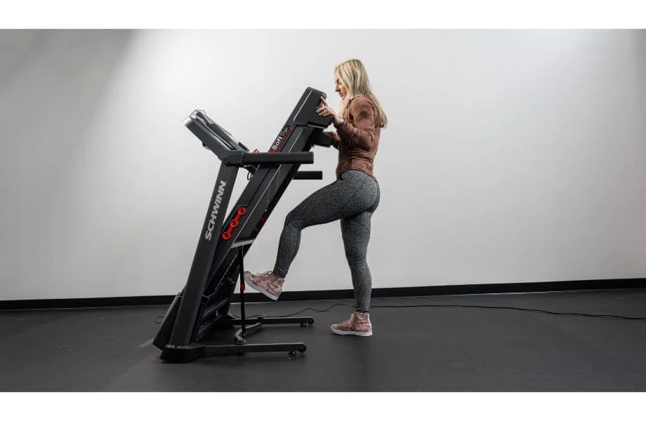 woman folding schwinn 810 treadmill