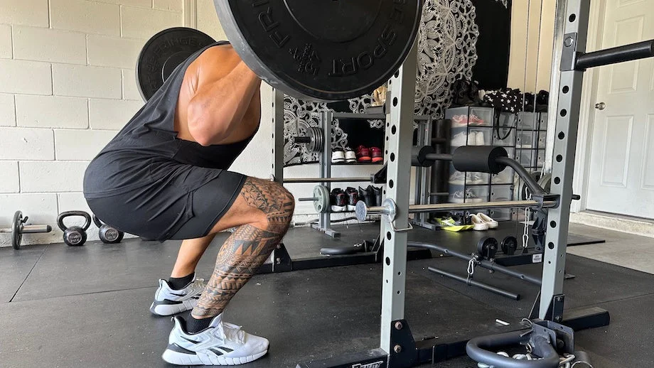 A man squatting in the Reebok Nano Gym Shoes