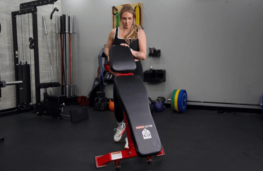 Our tester moving the Major Fitness Adjustable Bench into position for a training session