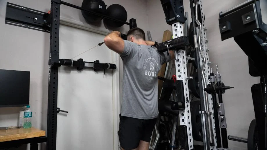 A man does rows using the wall-mounted MAXPRO Smart Connect