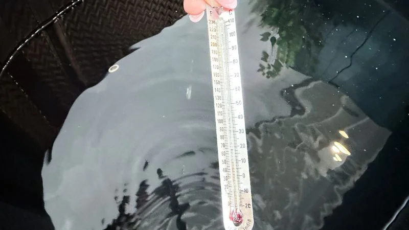 A thermometer showing the temperature of the water in the Nordik Recovery cold plunge tub