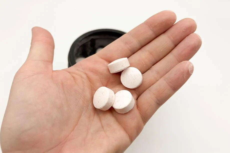 A hand holding Animal Creatine Chews