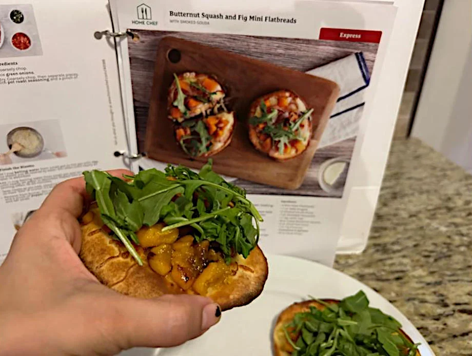 Person having prepared mini flatbreads with dates from Home Chef