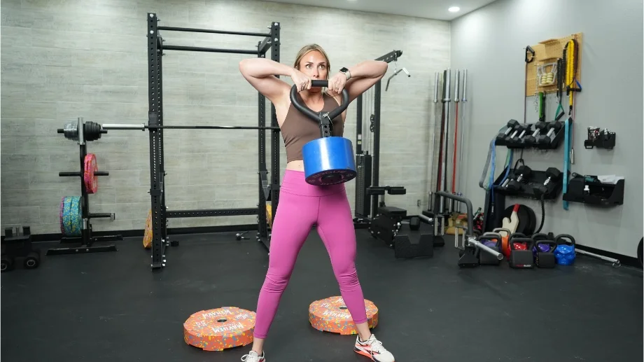 Lindsay lifting a Titan Fitness Plateloaded Kettlebell.
