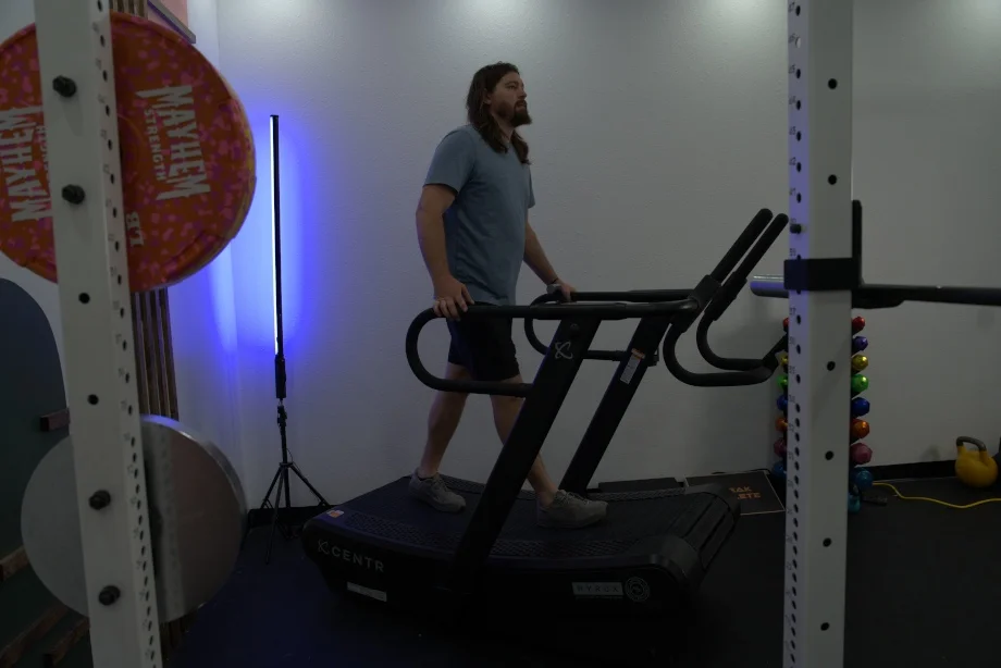 Side view of our tester walking on the Centr x HYROX Perform Tread