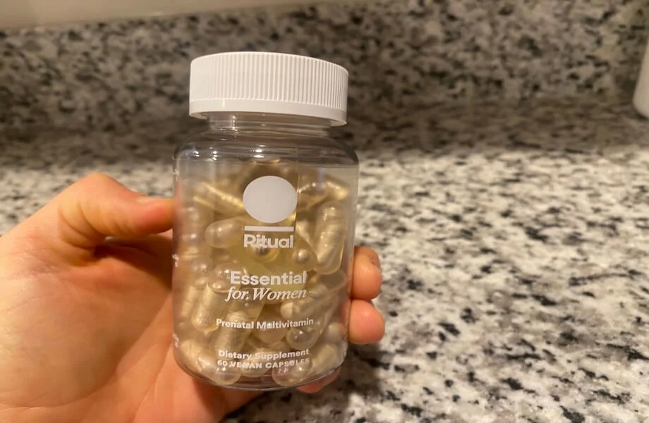 Our tester holding a container of Ritual Prenatal Multivitamin