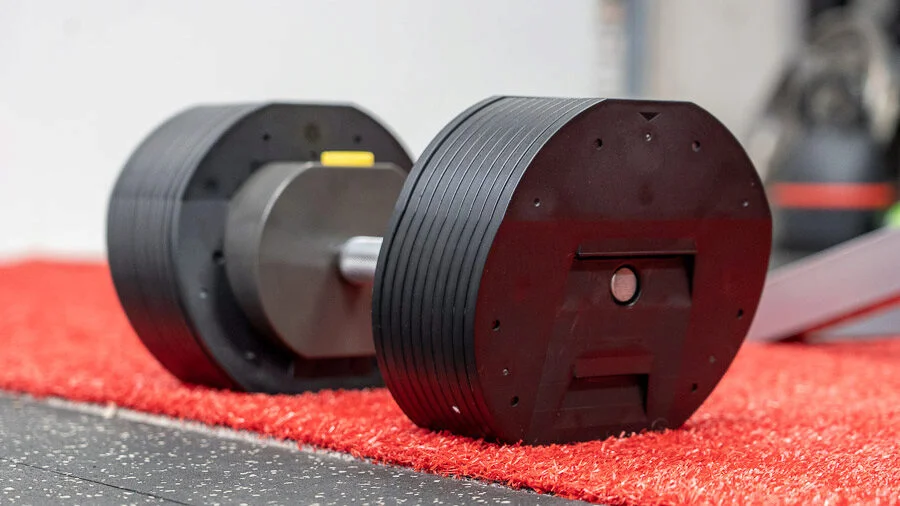 Regular picture of the adjustable dumbbells on the ground.