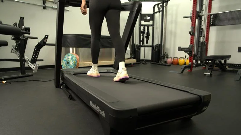 Rear view of a person walking on the NordicTrack Commercial 1250 treadmill.