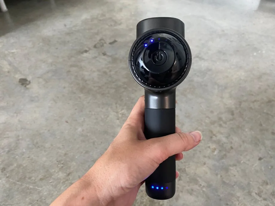 Holding the Renpho R3 massage gun