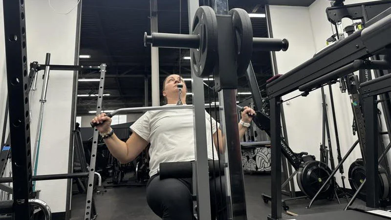 Our tester using the GDLF Lat Pulldown Machine