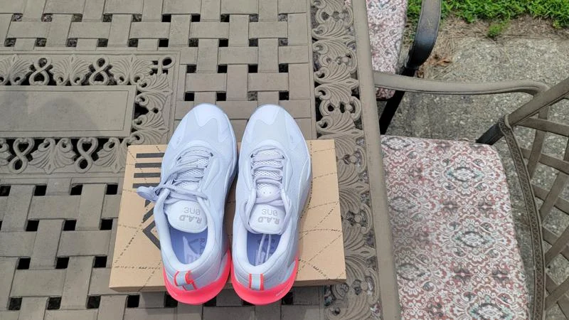 A pair of RAD One V2 training shoes perched on top of their shoebox A pair of RAD One V2 training shoes perched on top of their shoebox