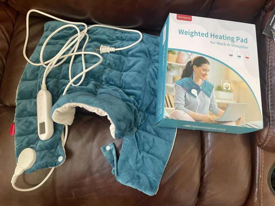 A Comfytemp Neck and Shoulder Heating Pad with the packaging