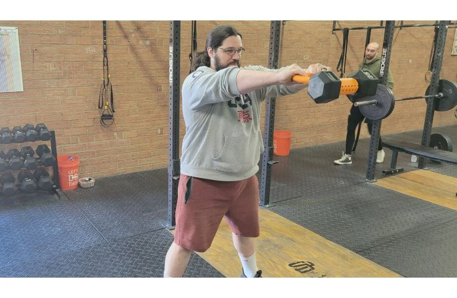 A man using the Kettle Gryp for KB swings
