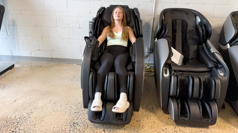 A product tester relaxing in the Bob and Brad Massage Chair