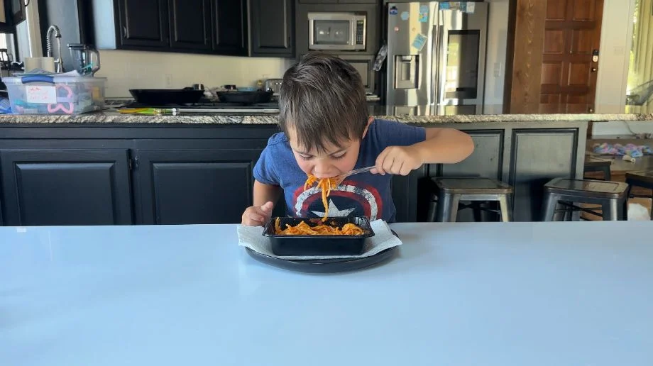 A boy eating a meal from Nurture Life