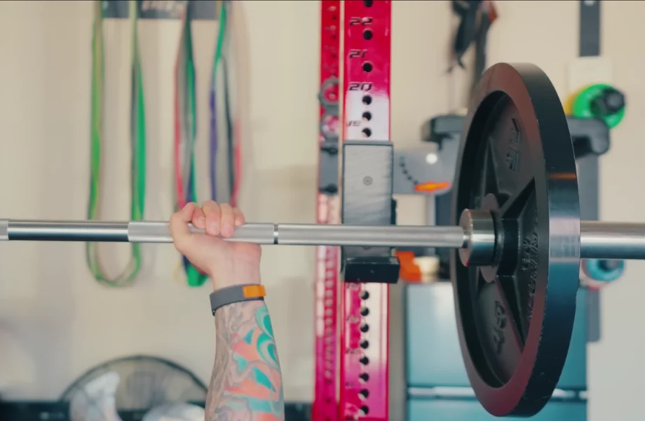 Our tester bench pressing with The Strength Co. Olympic Iron Barbell Plates