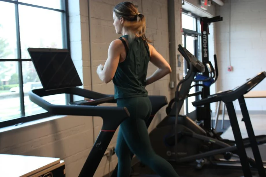 A woman running on the Peloton Tread