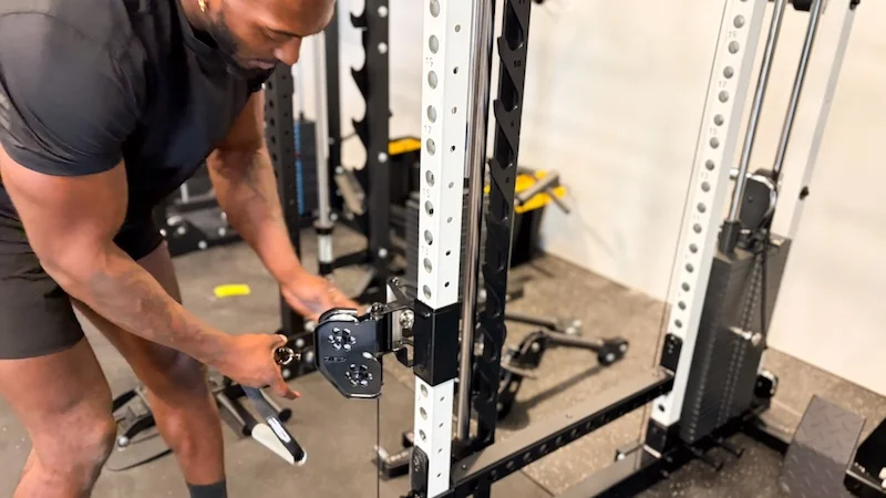 Product tester adjusting the trolleys on the REP Fitness Altitude Power Rack