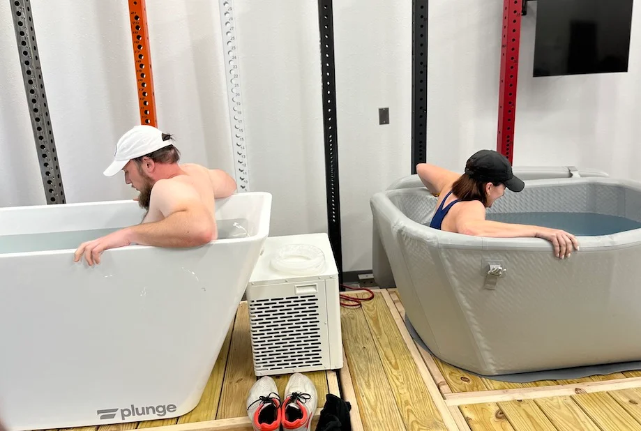 An image of two people in cold plunges for best cold plunge tub