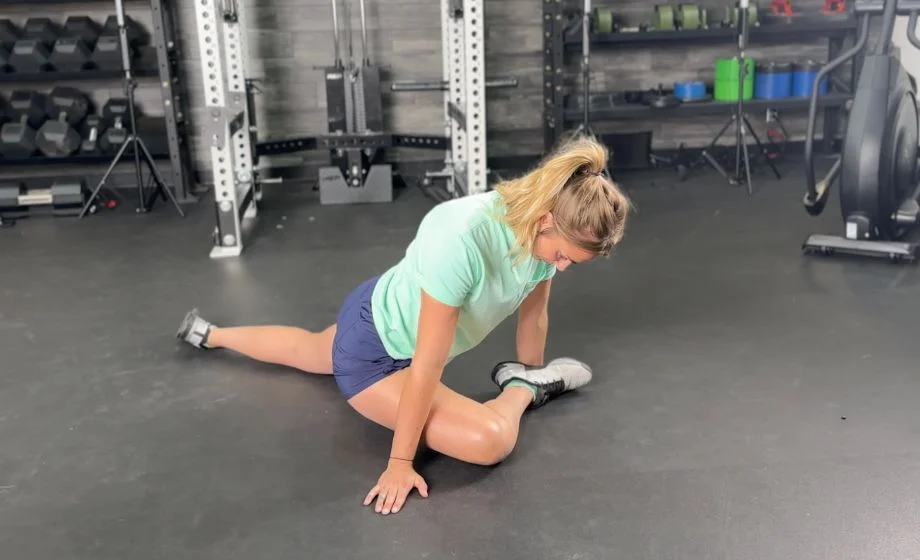 woman doing hip flexor stretch in half pigeon