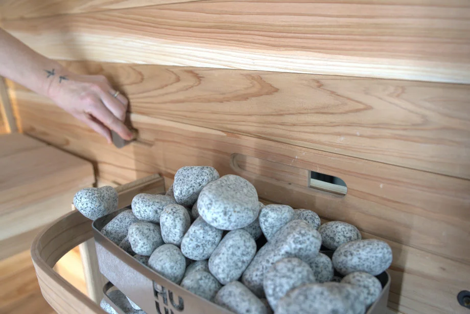 Our tester adjusts the air flow to hot rocks in a Plunge Sauna Mini