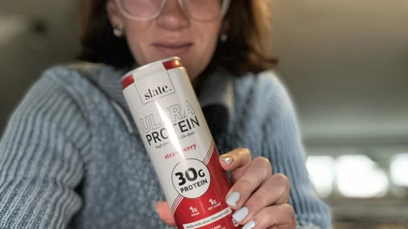 A person poses with one of the best protein shakes for weight loss.