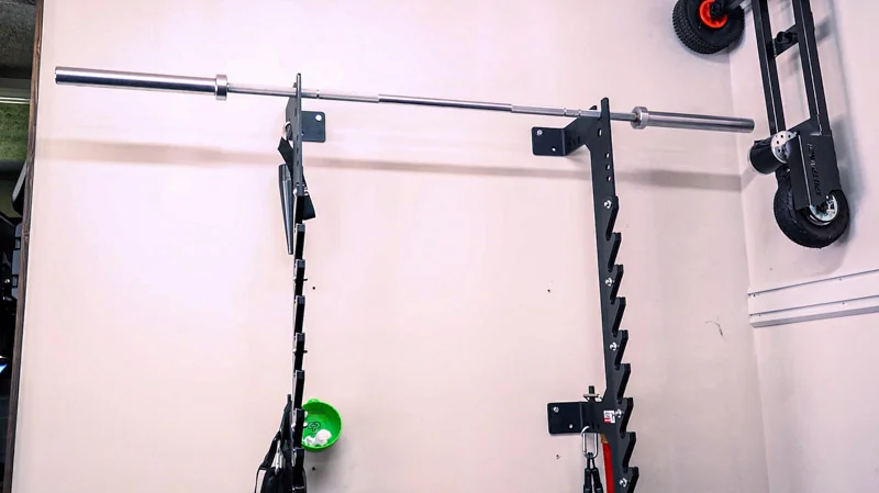 Sorinex OFF GRID Squat Rack bolted to the wall in a garage gym