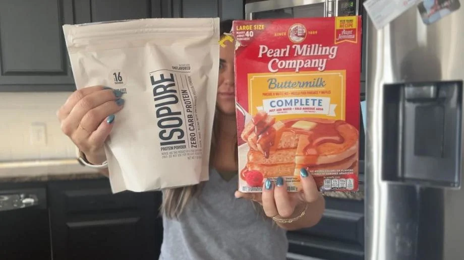 Woman holding Isopure Protein Whey Unflavored Pancake Mix