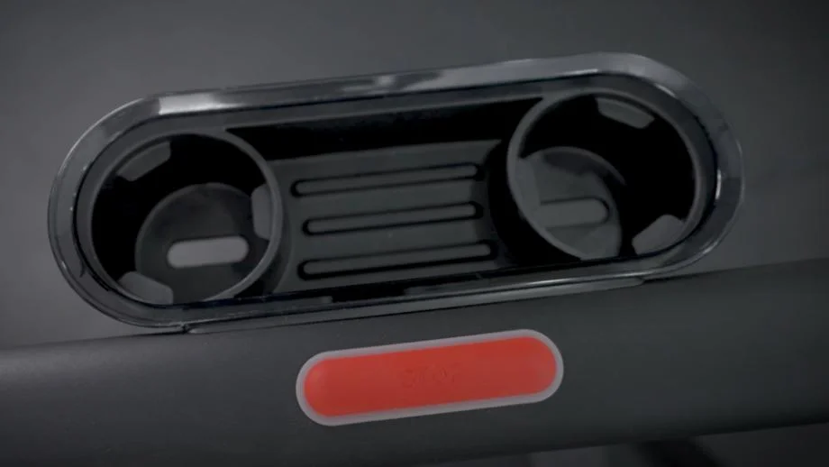 A close-up image of the two cupholders and storage tray of the Peloton Tread