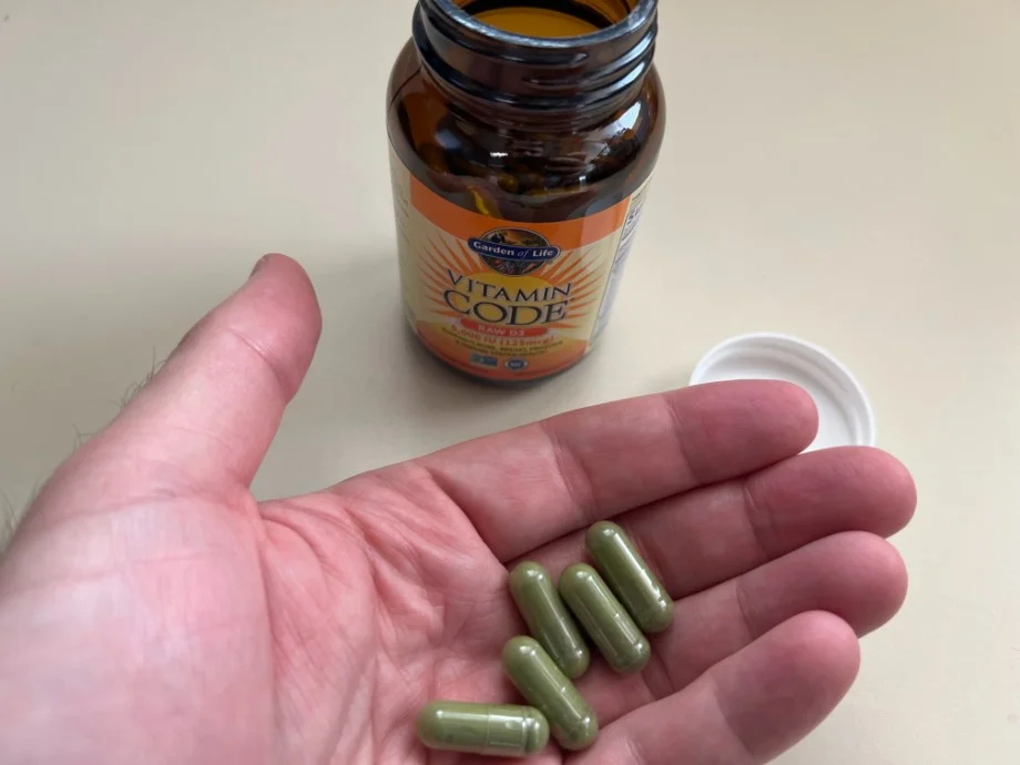 Person holding Garden of Life Vitamin D capsules in their hand