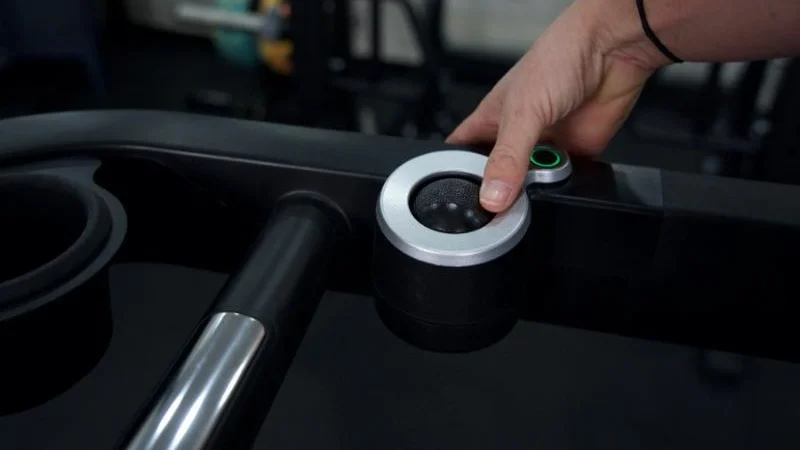 A close look at the thumb controls on the armrest of the Echelon Stride 8s treadmill.