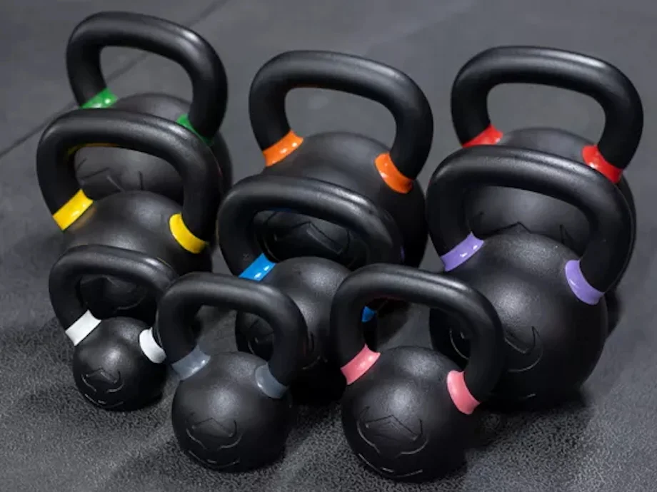 A set of Iron Bull kettlebells on gym flooring
