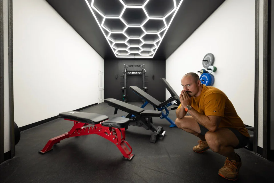 A man pictured with the best weight benches.