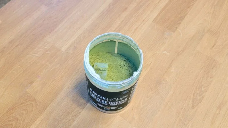 Looking at an open container of Brickhouse Nutrition Field of Greens