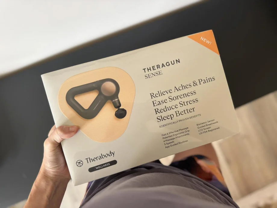 Our tester holding a Therabody Theragun Sense still in the box