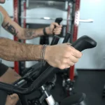 Our tester utilizing the upper moving handlebars on the Bowflex Max Trainer M6