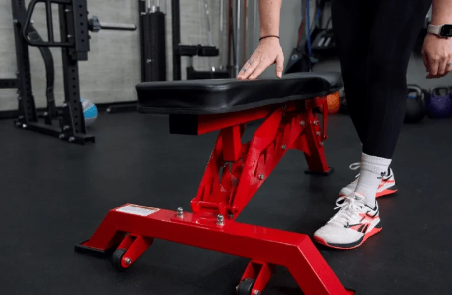 Our tester standing next to the Major Fitness Adjustable Bench in the GGR testing center