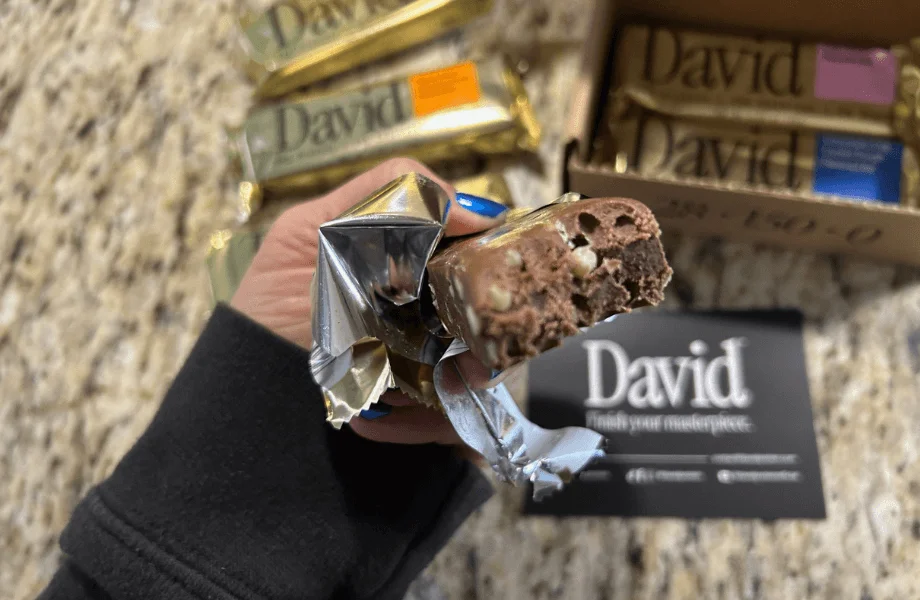 Our tester taking a bite of their David Protein Bar