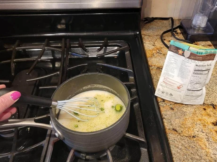 Our tester mixing Navitas Matcha Powder on the stove in almond milk