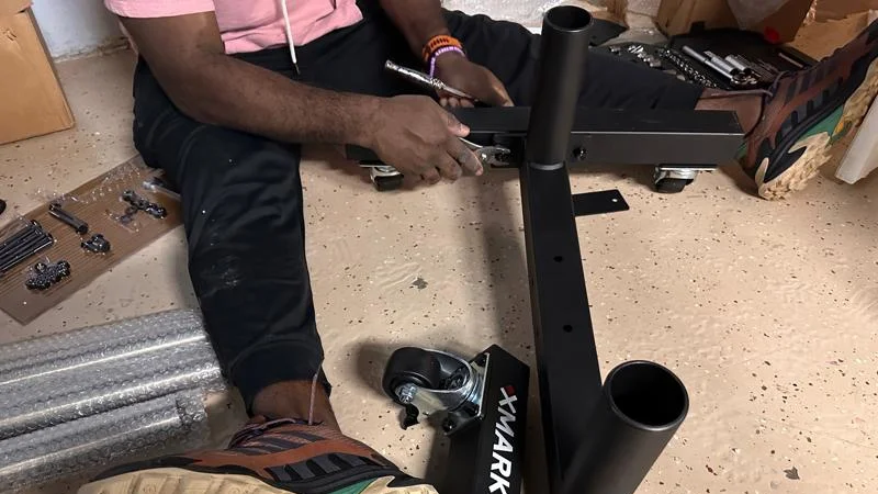 Our tester assembling the XMARK Olympic Plate Tree.