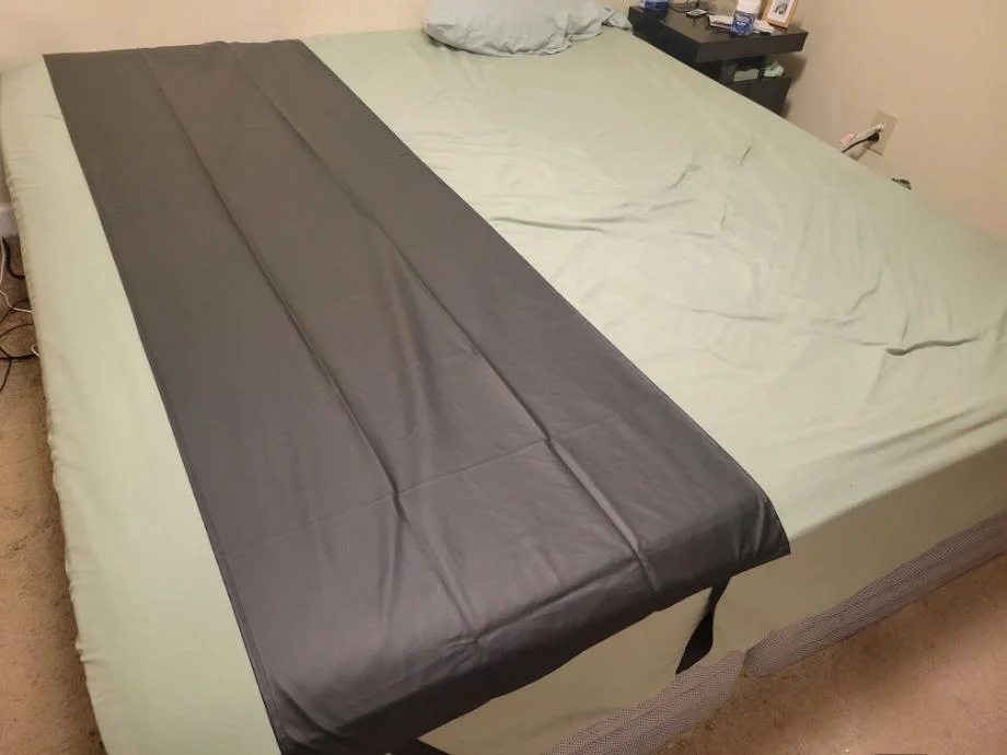 Earthing Elite Sleep Mat on a mattress