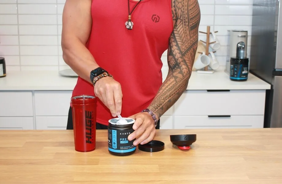 Our tester grabbing a scoop of Kaged Pre-Workout Sport