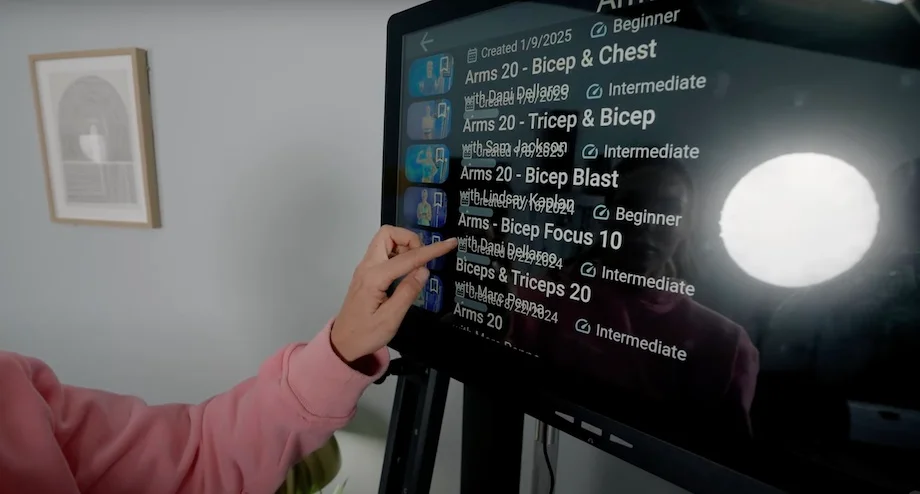 Lindsay Scheele, CPT scrolls throught workouts on the Echelon Strength Home.