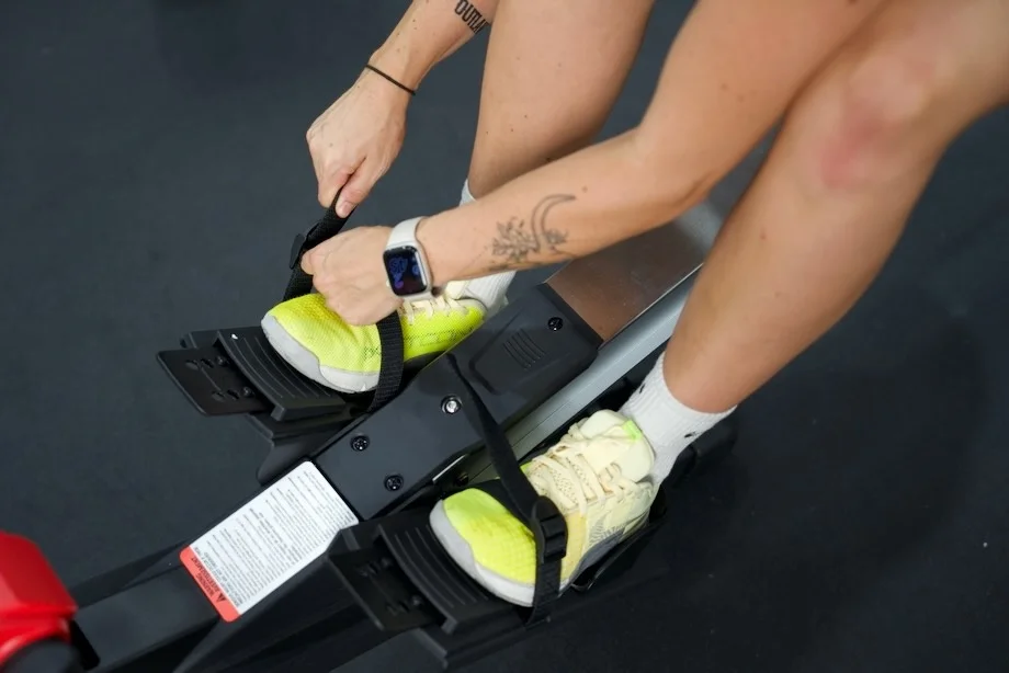 A person adjusts the foot strap on a Sole SR550